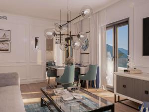 ein Wohnzimmer mit einem Tisch und einem Kronleuchter in der Unterkunft Mövenpick Hotel & Residences Teuta Kotor Bay in Kotor