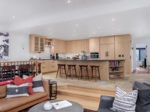 a living room and kitchen with a couch and a table at RMR: Tram Tower 5 Condo in Teton Village in Teton Village +18 photos