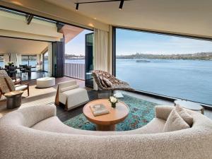 a living room with a large view of the water at Aliée Istanbul - A Paris Society Collection Hotel in Istanbul