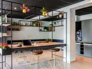 an office with a desk with a laptop and stools at ibis Bordeaux Nord Carbon Blanc in Carbon-Blanc