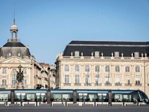a large building with a statue in front of it at ibis Bordeaux Nord Carbon Blanc in Carbon-Blanc +65 photos