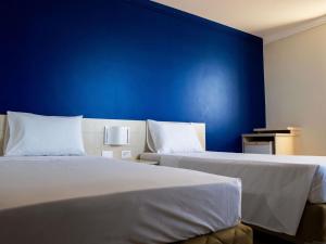 Ένα ή περισσότερα κρεβάτια σε δωμάτιο στο Ibis Styles Macaé +55 φωτογραφίες