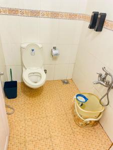 a bathroom with a toilet and a bag on the floor at Raaga on the Beach in Kannur +35 photos