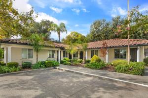 a house with a driveway in front of it at University Park Inn & Suites, an Ascend Collection Hotel in Davis