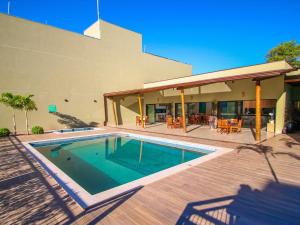 a swimming pool in front of a building with a patio at ibis Styles Bonito in Bonito