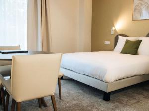 Ένα ή περισσότερα κρεβάτια σε δωμάτιο στο Adagio Access Bordeaux Sud Pessac