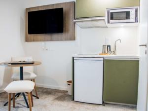 a small kitchen with a sink and a table at Adagio Access Bordeaux Sud Pessac in Pessac +39 photos