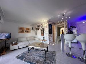 a living room with a couch and a table at Seaview Holiday Home Kalkan in Kalkan