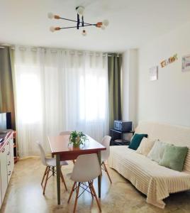 a living room with a table and a couch at Trilocale vacanza Riccione in Riccione