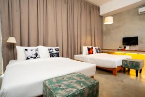 a hotel room with two beds and a tv at Talent Residence in Phnom Penh +40 photos