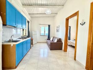 a kitchen with blue cabinets and a couch in a room at Residence Araba Fenice Tropea in Tropea +259 photos