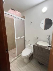 a bathroom with a toilet and a sink and a shower at casa fresh in Rodadero