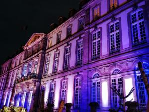 a building lit up in purple and white at Entre 2 Rives Strasbourg-Kehl in Kehl am Rhein