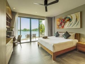 a bedroom with a bed and a view of the water at Lakeside 5-BR New Pool Villa in Gated Community in Chalong  +33 photos