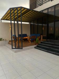 a building with a deck with tables and benches at albaha harmony resort in Al Baha +14 photos