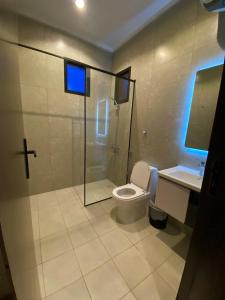 a bathroom with a toilet and a shower and a sink at albaha harmony resort in Al Baha