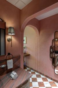 a room with a table and a checkerboard floor at Abode Jaipur in Jaipur +55 photos