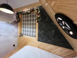 a bedroom with a window with christmas decorations at Apartamenty pod Tatrami in Zakopane