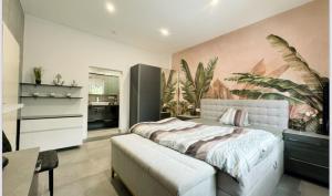 a bedroom with a bed with a large painting on the wall at Speyer Ferienwohnung Apartment 5 in Speyer