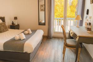 a bedroom with a desk and a bed and a desk and chair at Logis Hôtel Blue Garden in Grandvillers
