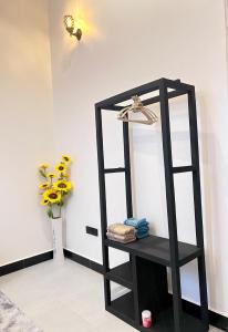 a black shelf with a mirror in a room at Ynna Stays in Dar es Salaam
