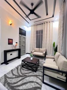 a living room with a couch and a table at Ynna Stays in Dar es Salaam