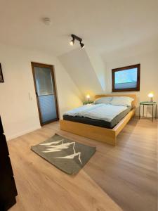 a bedroom with a bed and a rug at Ferien im Schwarzwald Dörlinbach II in Schuttertal