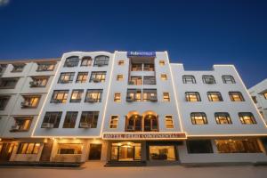 a white building with a hotel benefit committee sign on it at FabHotel Delhi Continental in New Delhi