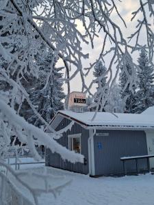 a sign on top of a shed in the snow at Hostel Tikka in Rovaniemi