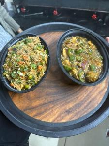 two bowls of food sitting on top of a table at Hotel Green Forest Mahableshwar in Mahabaleshwar