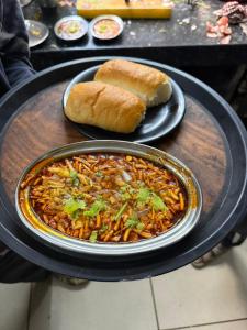 a table with a plate of food and a plate of bread at Hotel Green Forest Mahableshwar in Mahabaleshwar