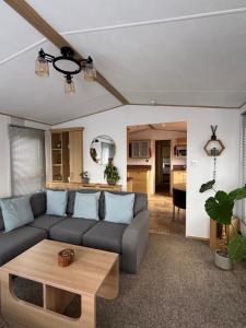 a living room with a couch and a table at Seven Bays Hideaway in St Merryn