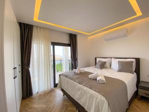 En eller flere senge i et værelse på Pandora G Villa