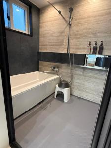 a bathroom with a bath tub and a shower at Mori Sapporo in Sapporo +37 photos