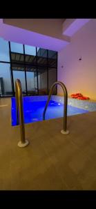 a swimming pool with two metal bars in a room at albaha harmony resort in Al Baha