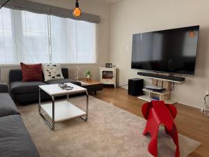 a living room with a large flat screen tv at Mori Sapporo in Sapporo