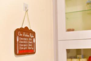 a chalkboard sign hanging on a door at Luna's Solace-The Rustic Stay-Ease in Guwahati +2 photos