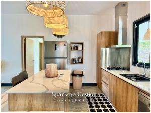 a kitchen with a table and a counter top at SG19 Villa Serenity Lux in Calodyne