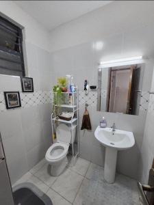 a bathroom with a toilet and a sink at 1 Bedroom Apartment near UN GIGIRI and US Embassy Village Market in Nairobi +19 photos