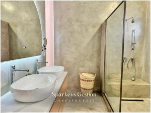 a bathroom with two sinks and a shower at SG19 Villa Serenity Lux in Calodyne