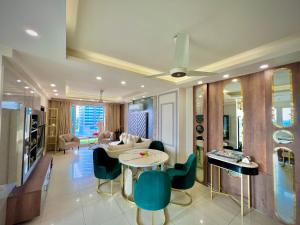 a living room with a table and chairs at Guest Nest Executive Stay- Elysium Tower Opposite Centaurus Mall Islamabad in Islamabad