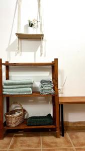 a wooden shelf with towels and a table at Casa MªÁngeles in Puebla de Arenoso +35 photos