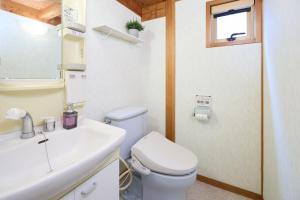 a bathroom with a white toilet and a sink at casa de tsuru in Osaka +64 photos