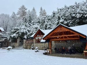 a house with snow on the roof of it at Apartament Nad Potokiem in Muszyna