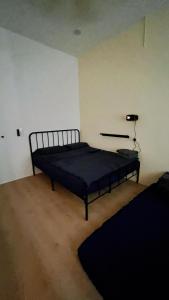 a bedroom with a black bed in a room at D Cloud Homestay & Room in Kajang