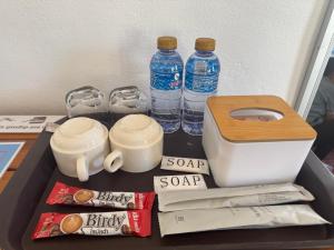 a drawer with bottles of water and other items on it at Le Jardin 2 Organique Guesthouse Vang Vieng in Vang Vieng
