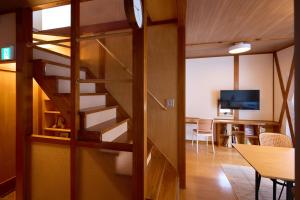 a spiral staircase in a room with a dining room at casa de tsuru in Osaka