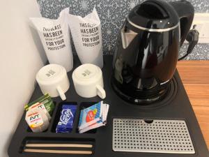 a blender on a counter with some food and coffee at SABU's GRAND ROYALE HOTEL in Trivandrum