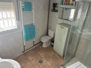 a bathroom with a toilet and a glass shower at Casa Rural en BRAÑOSERA in Brañosera +17 photos