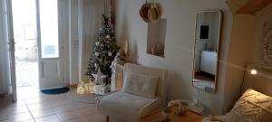a living room with a christmas tree and a chair at Animæ Caveoso Suite in Matera